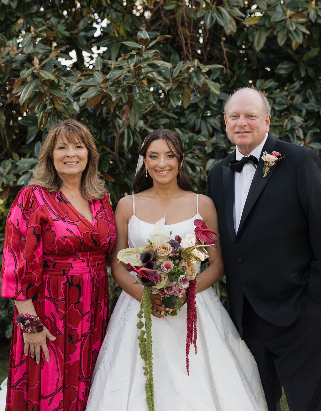 Bride and parents with bouquet, corsage, and boutonniere at the Callie & Jeremy wedding — designed by Lael Florals