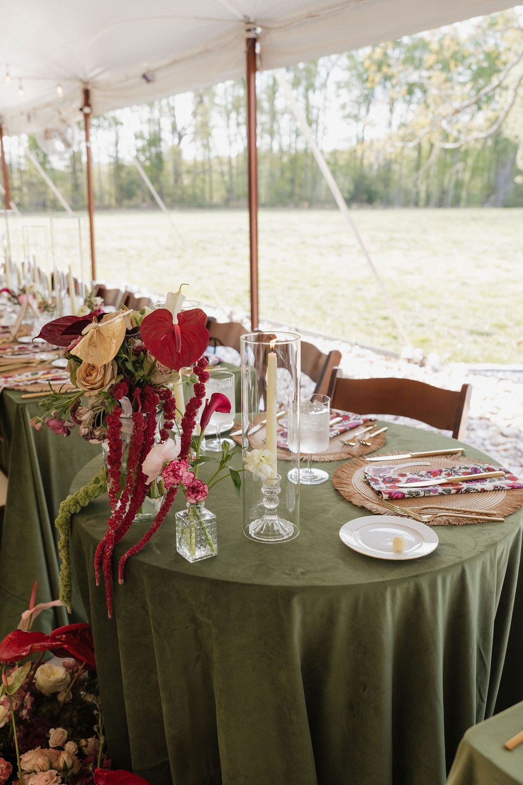 Anthurium and amaranthus centerpiece trailing onto a green velvet table at the Callie & Jeremy wedding — designed by Lael Florals