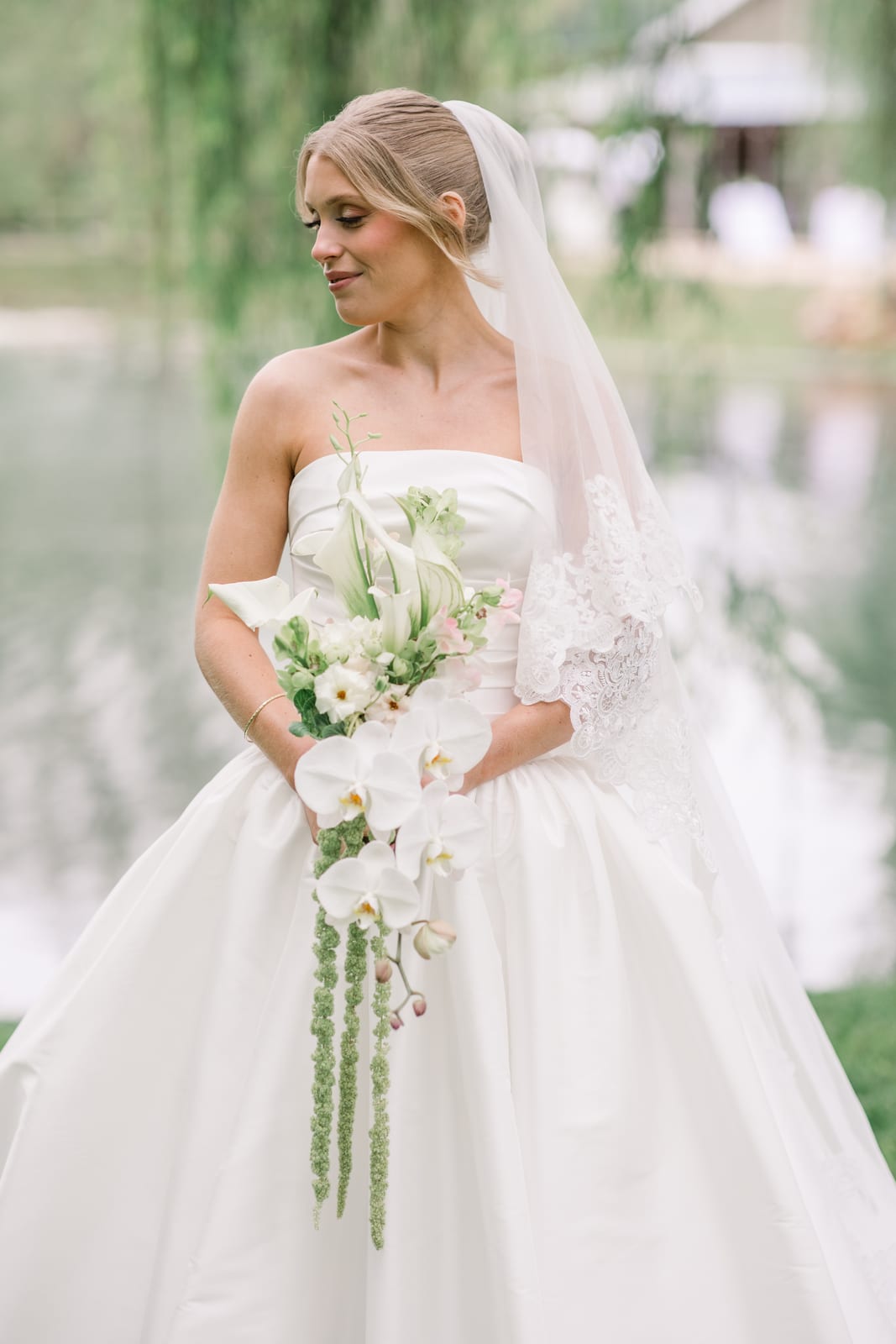 Bridal portrait with lace veil and cascading orchid bouquet at the Gabby & Matt wedding — designed by Lael Florals