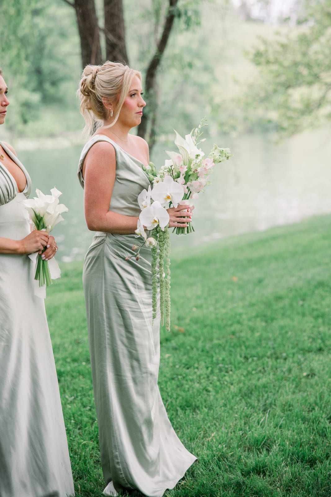 Bridesmaids in sage holding white orchid and amaranthus bouquets at the Gabby & Matt wedding — designed by Lael Florals