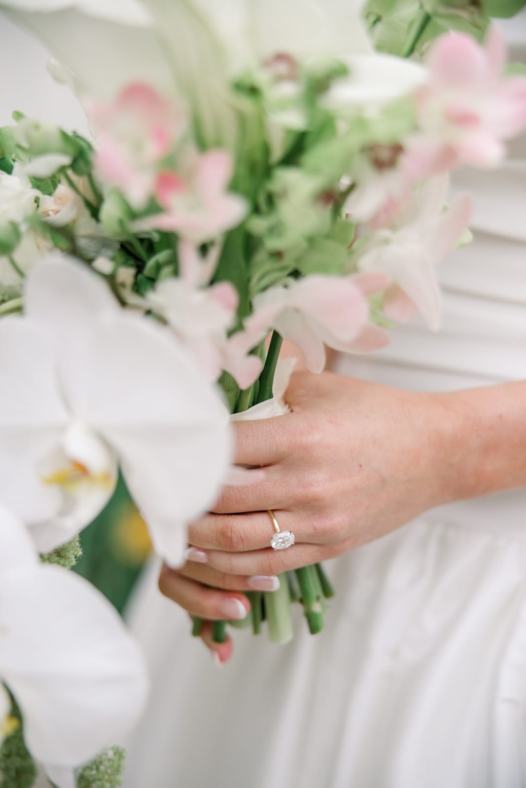Engagement ring detail on the bride's orchid and calla bouquet at the Gabby & Matt wedding — designed by Lael Florals