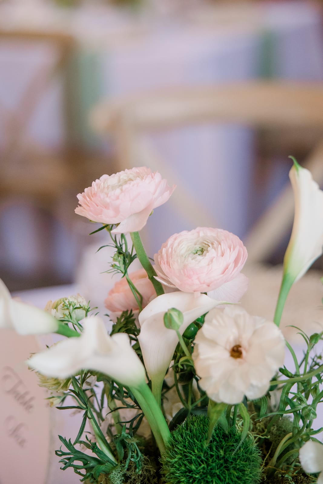 Macro of blush ranunculus and calla lilies in a centerpiece at the Gabby & Matt wedding — designed by Lael Florals