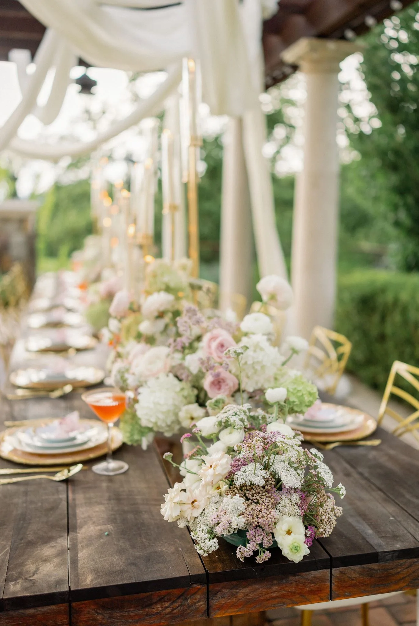 Guest table set with a blush and ivory floral runner