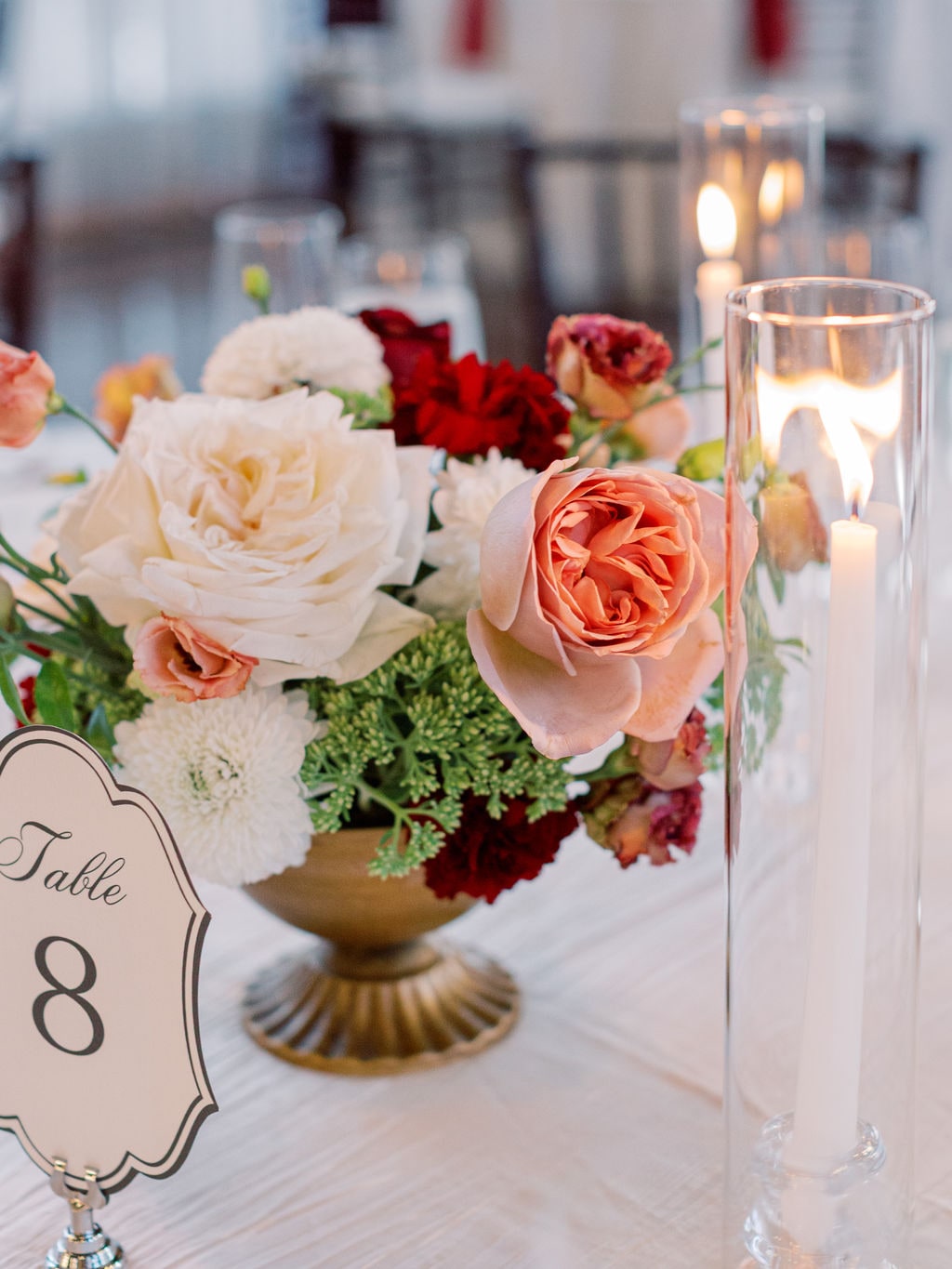 The table eight compote with its calligraphed number and taper candles at the Karlie & Hank wedding — designed by Lael Florals