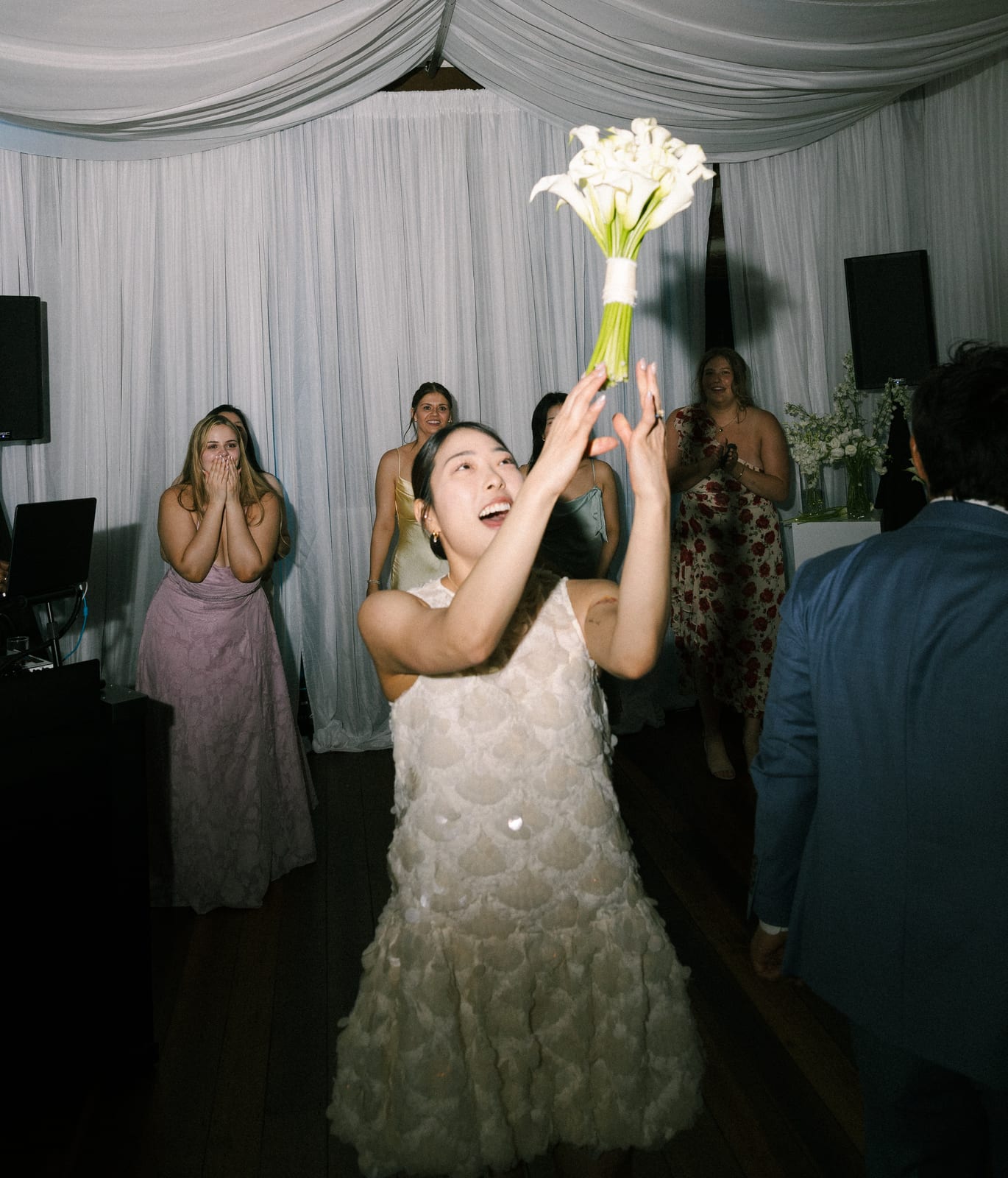 Bride tossing her white calla lily bouquet at the Sharon & Matt wedding — designed by Lael Florals
