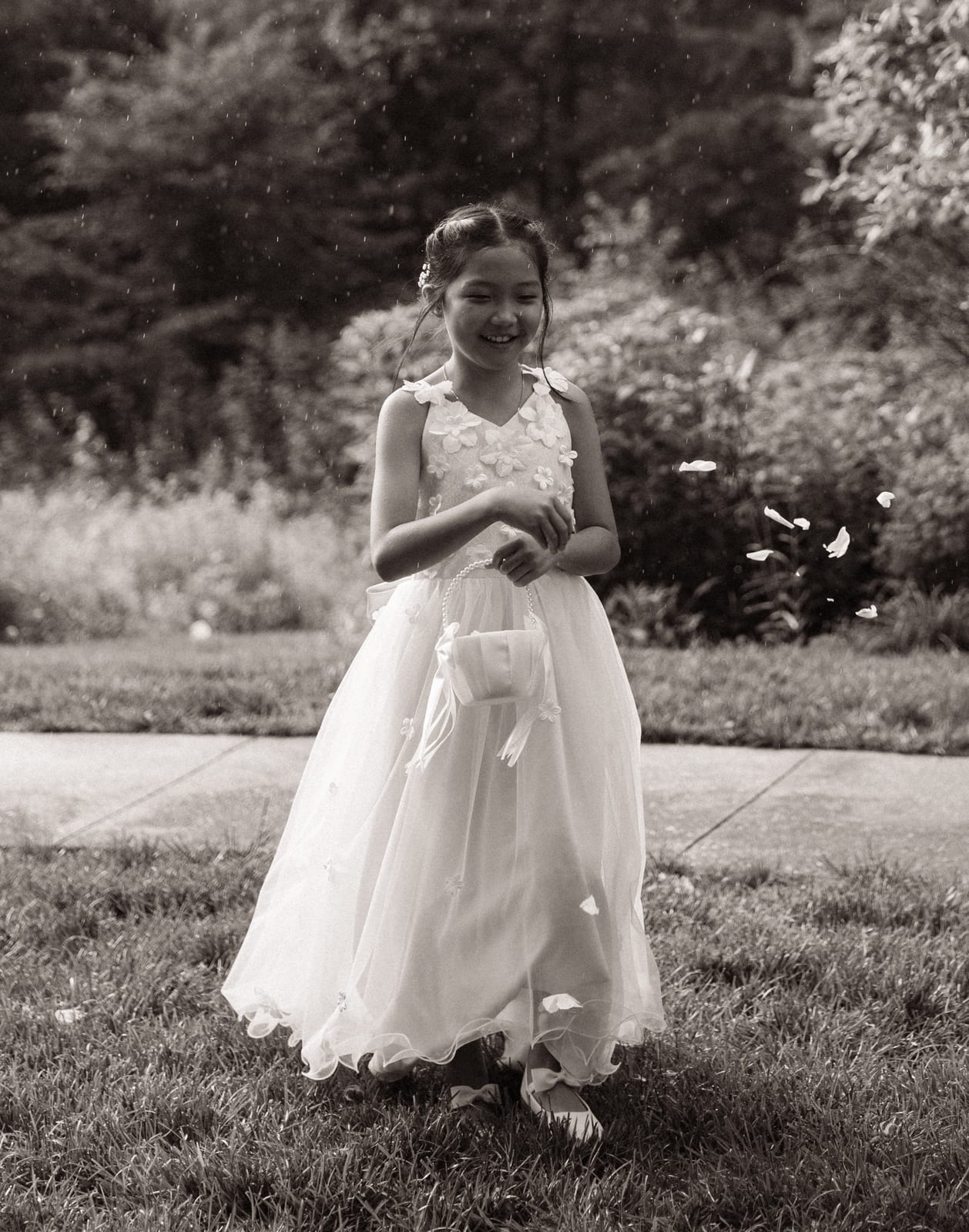 Flower girl with her petal basket in the rain at the Sharon & Matt wedding — designed by Lael Florals