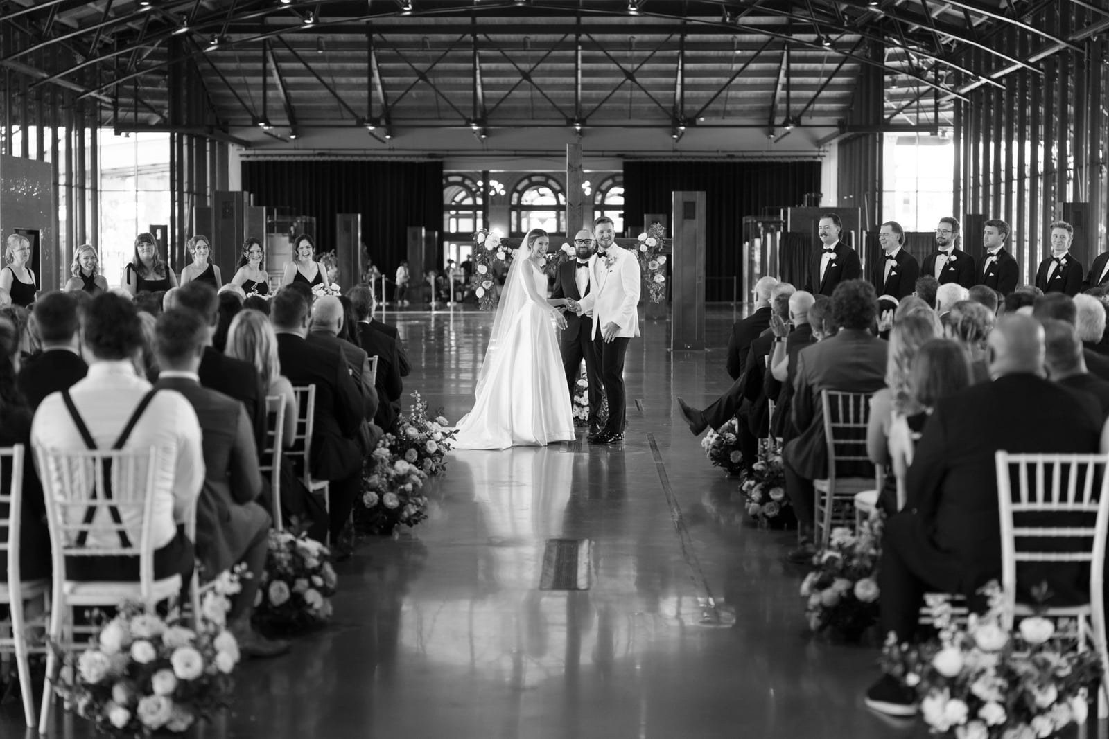 Loose, airy garden-style floral arrangement at an indoor wedding