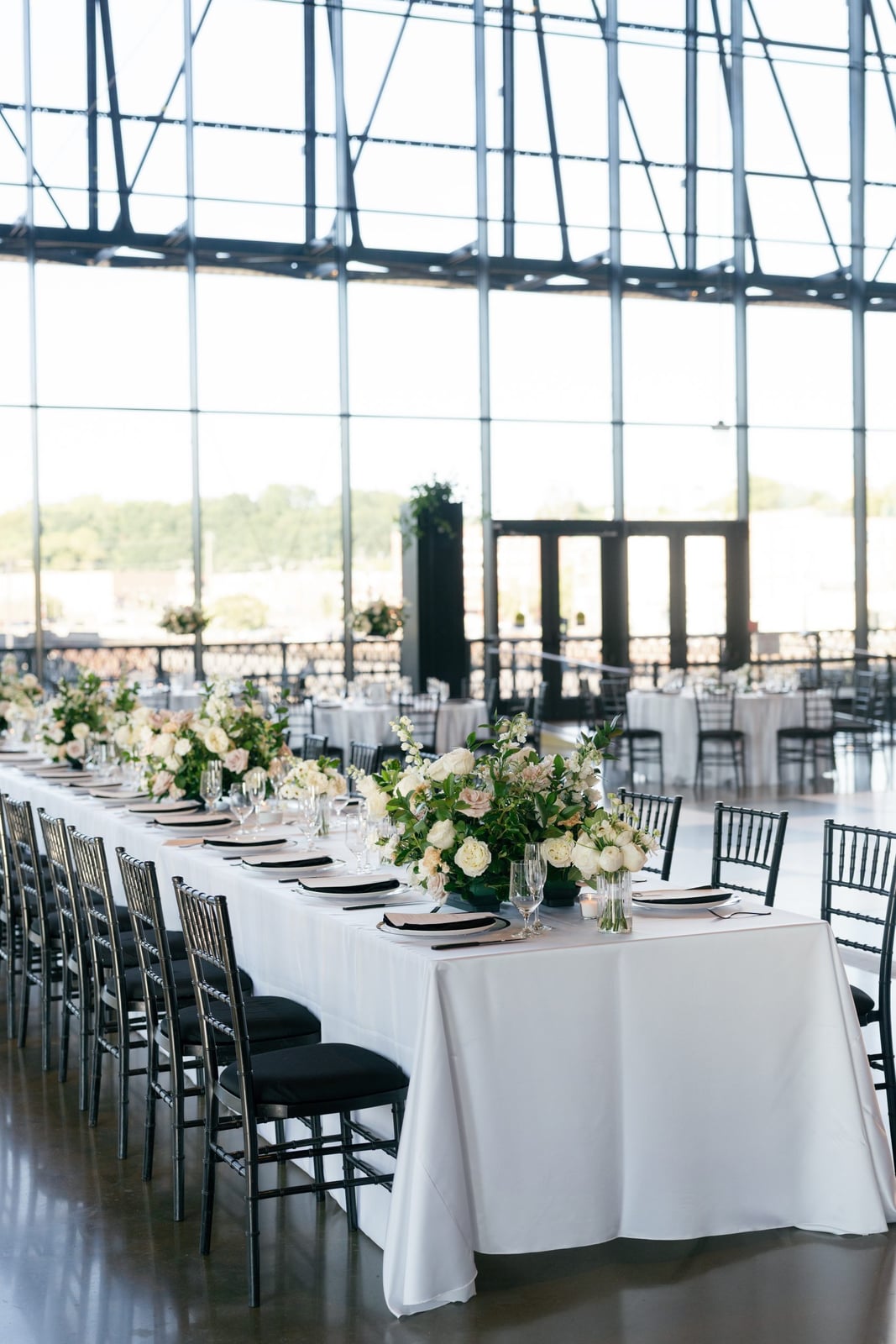 Indoor wedding florals softening an industrial space with garden-inspired arrangements