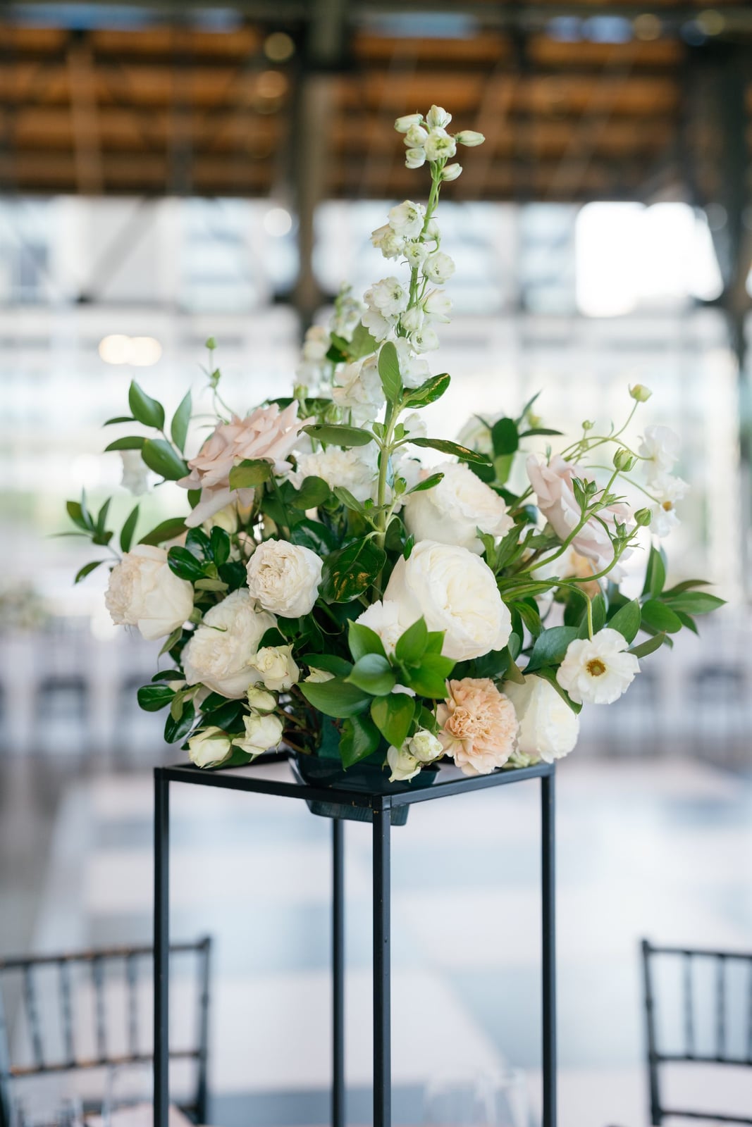 A photographed indoor wedding moment showing garden florals in soft light